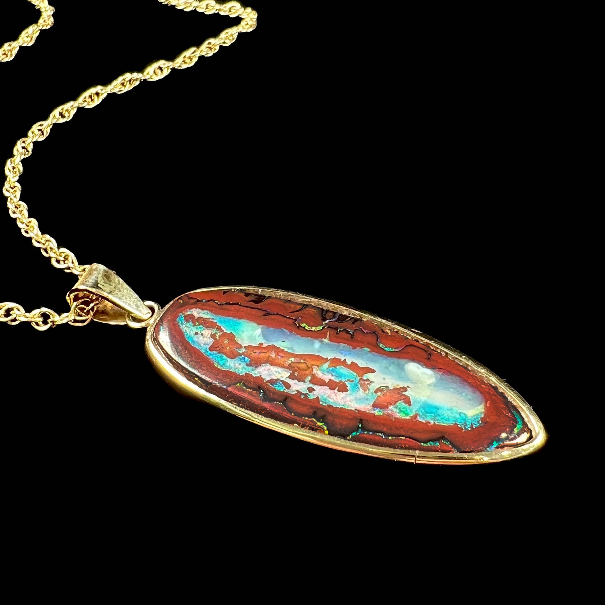 A yellow gold pendant set with a natural Yowah nut boulder opal stone.