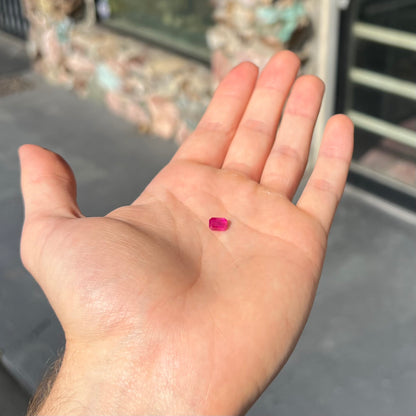 A natural, emerald cut Burma ruby with a purplish pinkish red color.