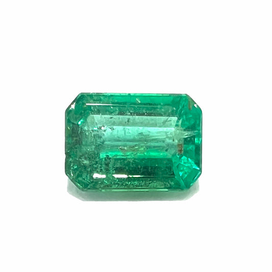 A loose, natural emerald gemstone.  The stone is emerald cut.