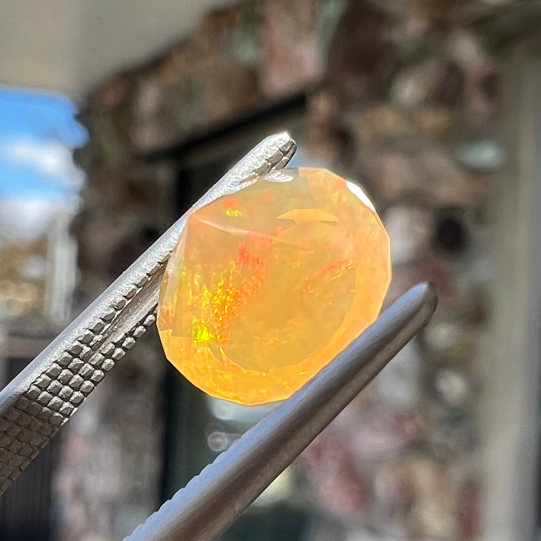 A loose, faceted round cut fire opal from Mexico.  The stone is yellow orange in body color.