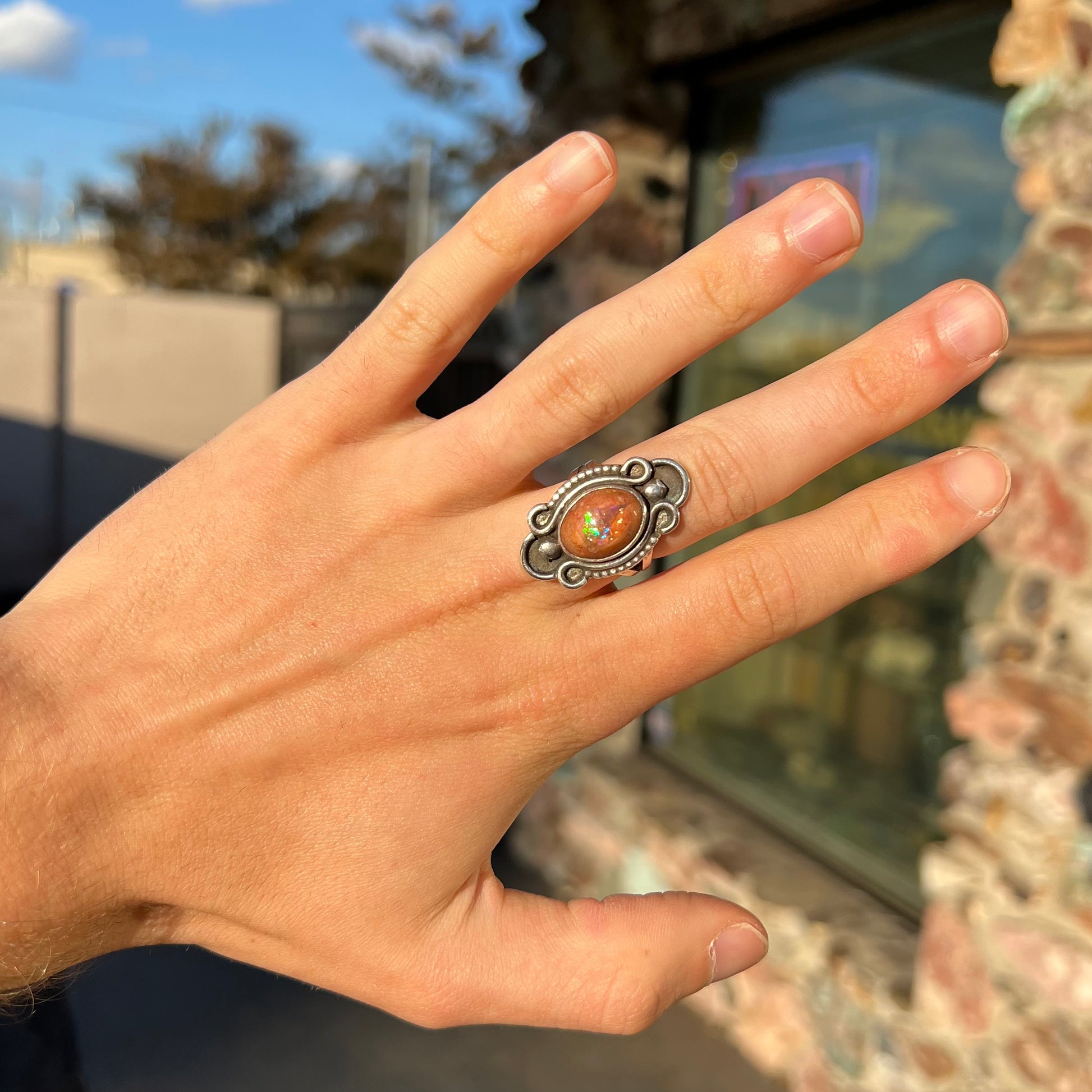 A vintage, Navajo style sterling silver ring set with an oval cabochon cut cantera fire opal stone.