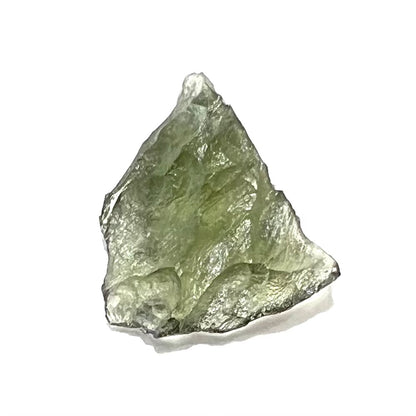 A natural, rough moldavite crystal.  The stone is green color and transluscent.