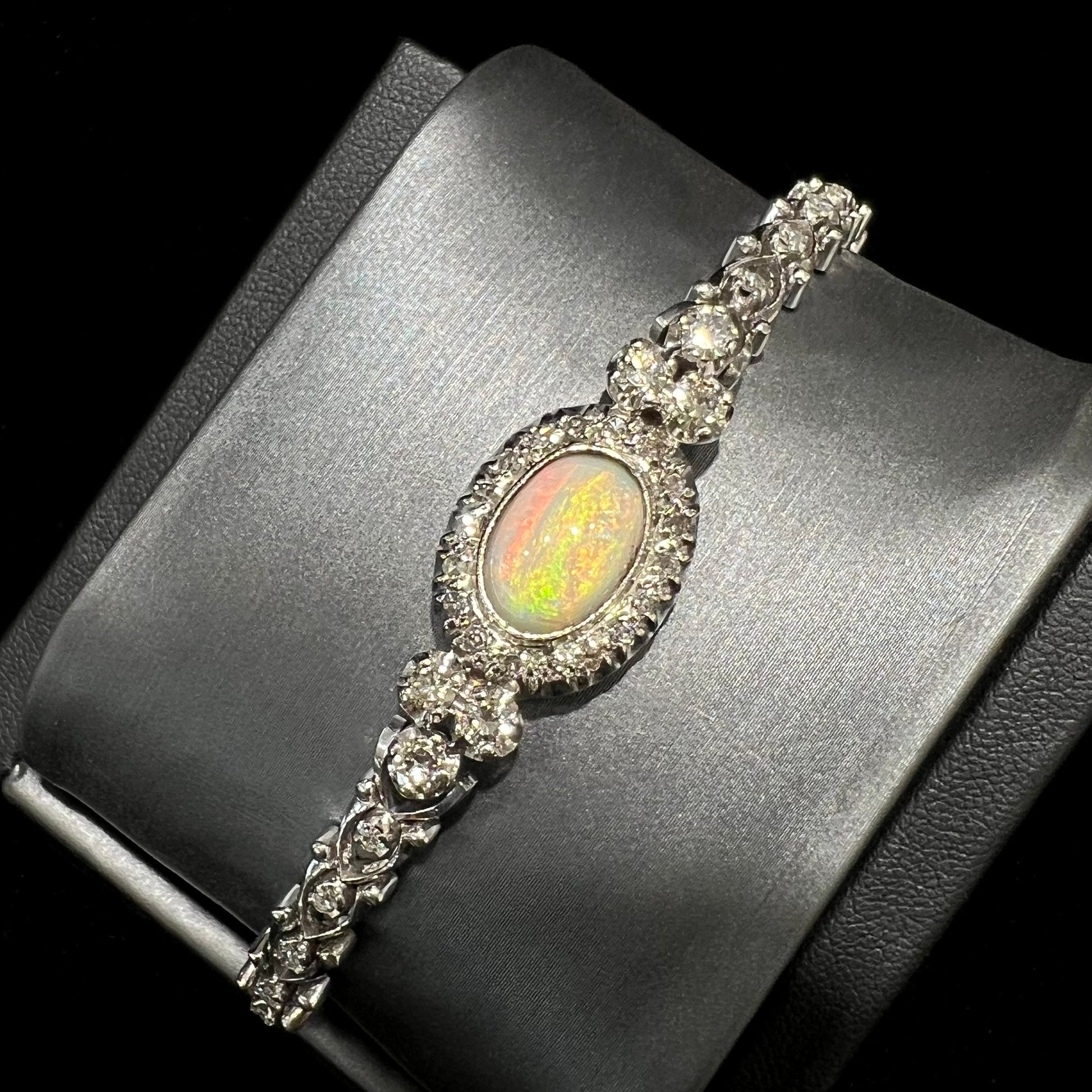 A ladies' vintage, 1930's natural opal bracelet set with accent diamonds in white gold.