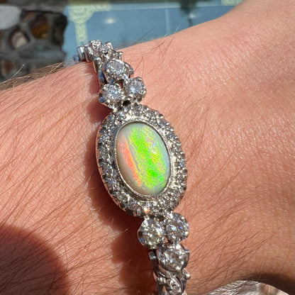 A ladies' vintage, 1930's natural opal bracelet set with accent diamonds in white gold.