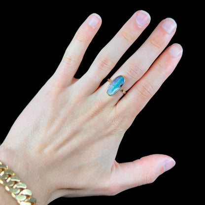 Ladies' yellow gold solitaire ring bezel set with a natural green striped boulder opal from Quilpie, Australia.
