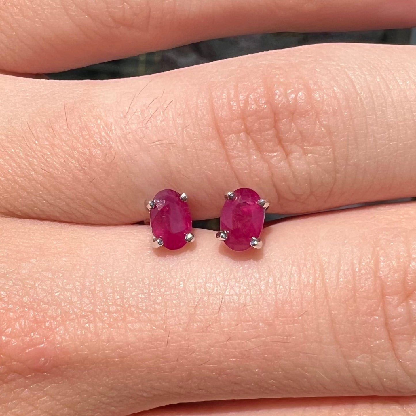 A pair of natural Burma ruby stud earrings set in white gold.  The rubies are a purplish red color.
