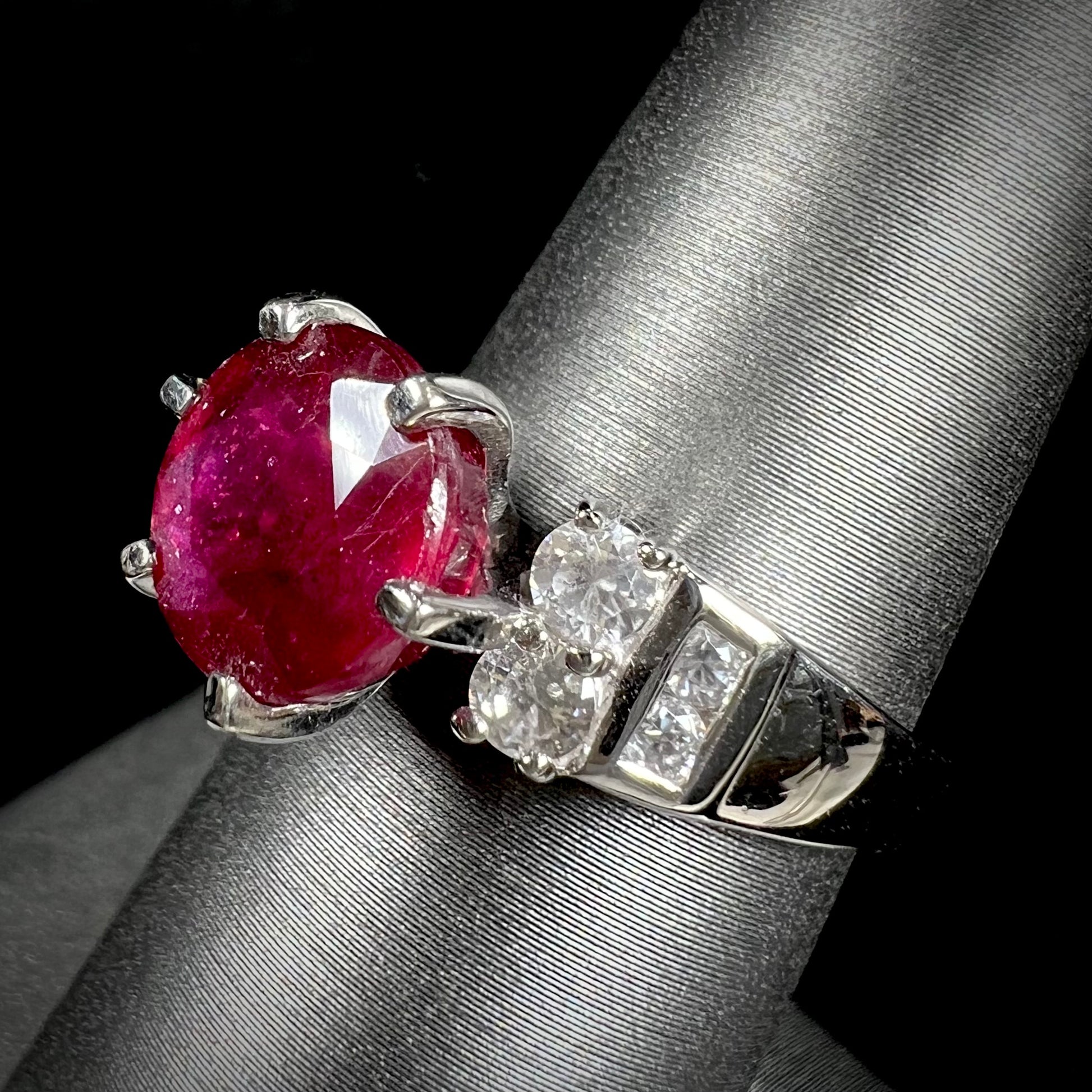 A ladies' sterling silver natural ruby and white zircon ring.  The real ruby is glass filled.