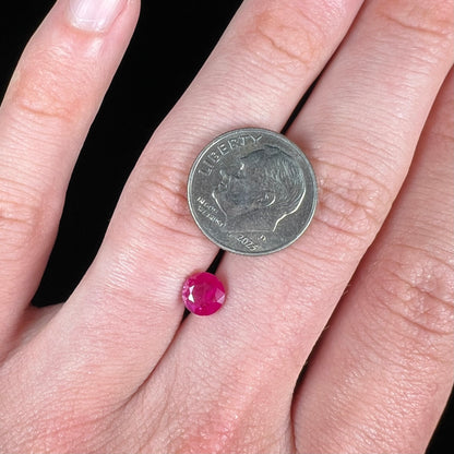 A faceted round brilliant cut Burma ruby gemstone.  The stone is certified as natural by Guild Laboratories.