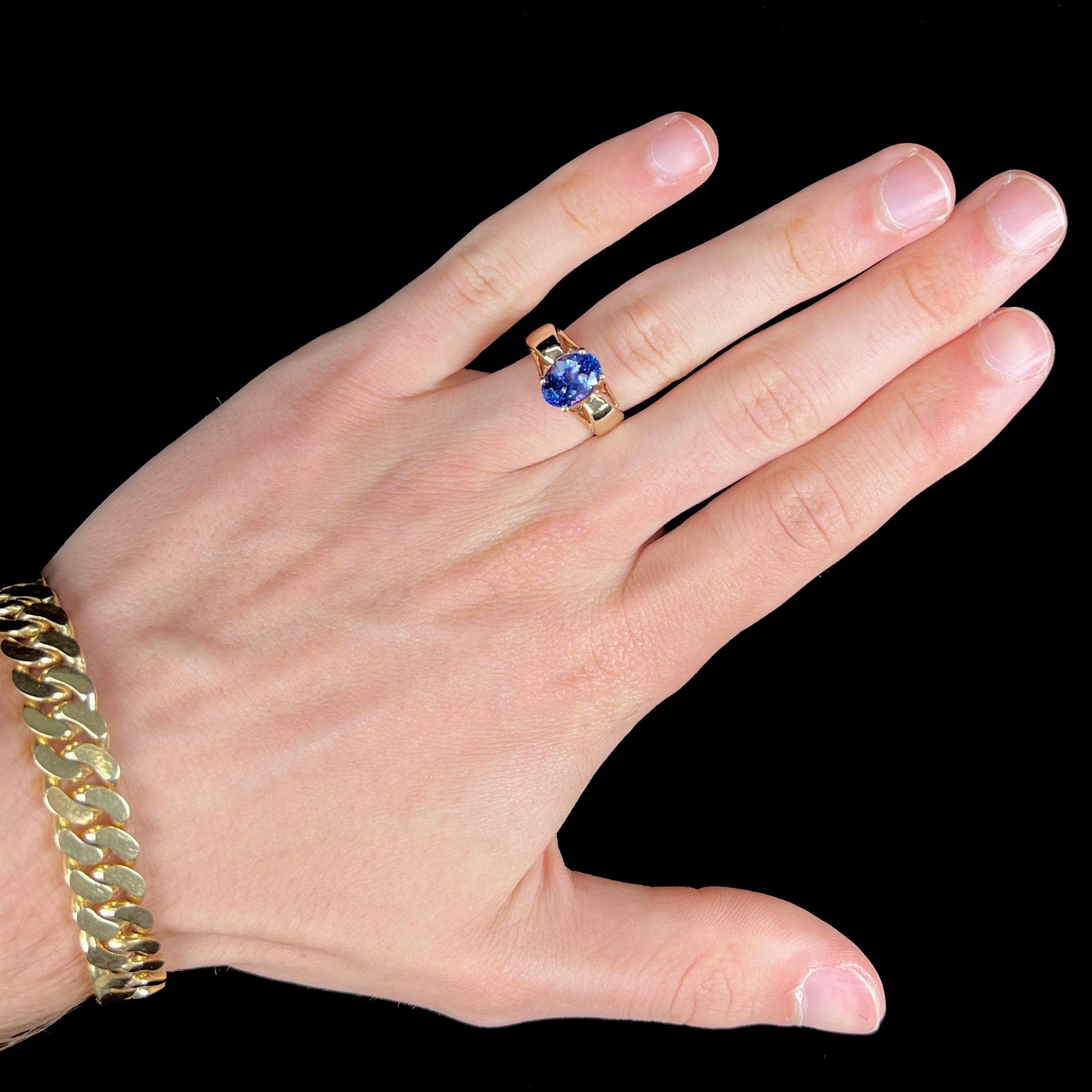 A ladies' oval cut tanzanite solitaire ring set in yellow gold.
