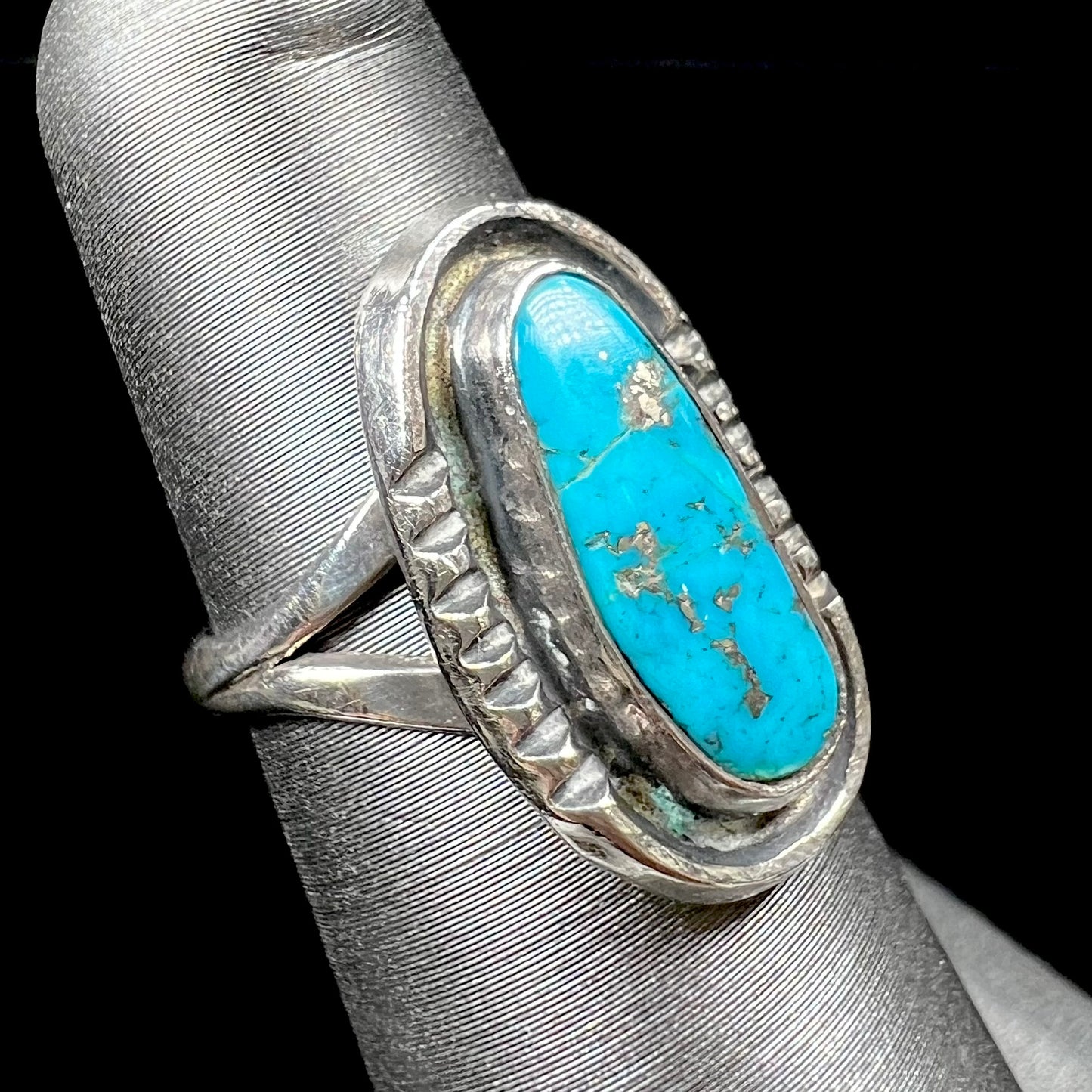 A handmade sterling silver Navajo style ring set with a Morenci turquoise stone.