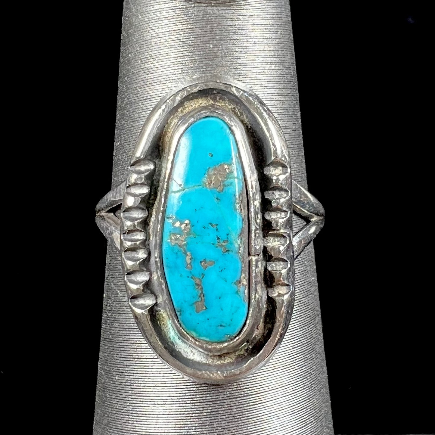 A handmade sterling silver Navajo style ring set with a Morenci turquoise stone.