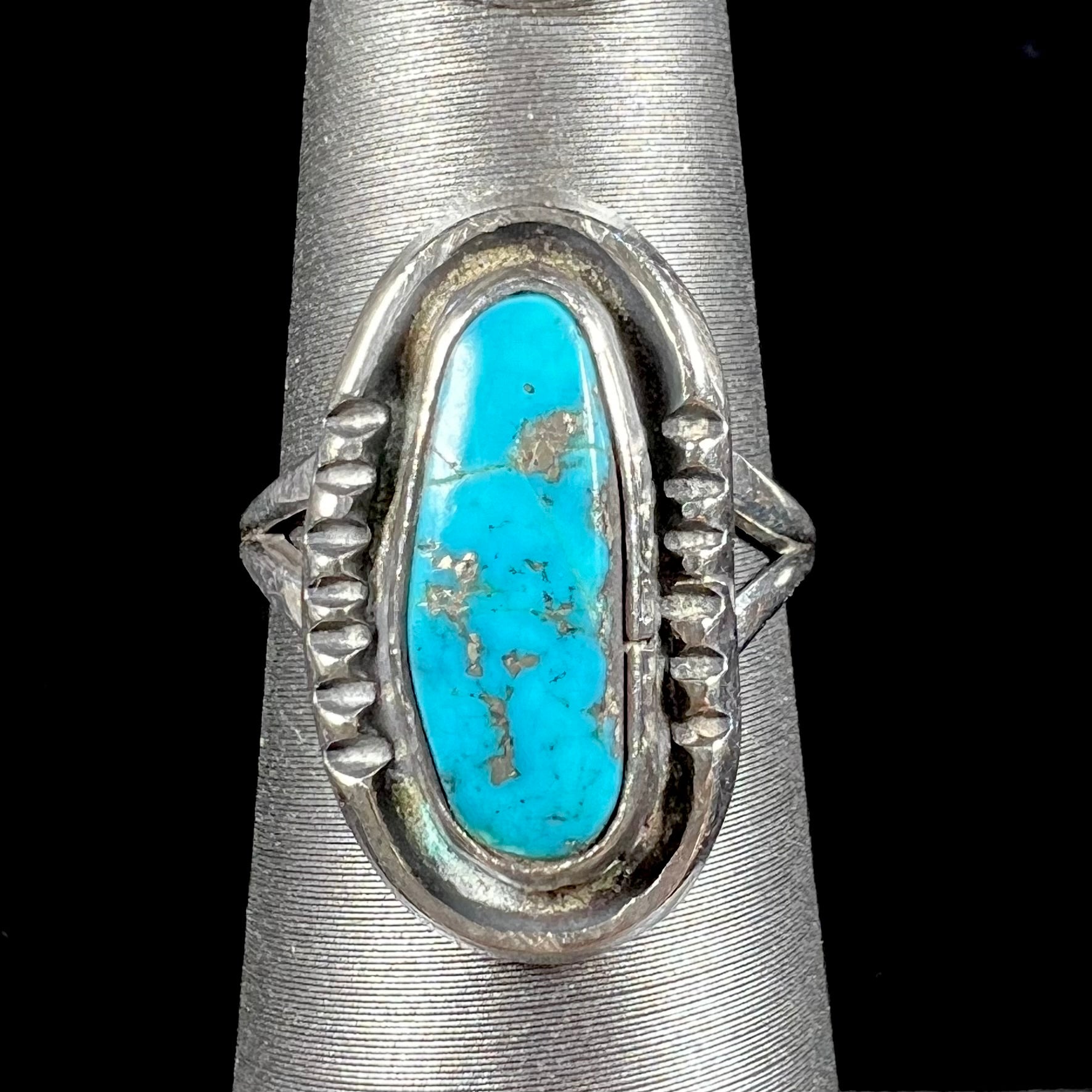 A handmade sterling silver Navajo style ring set with a Morenci turquoise stone.