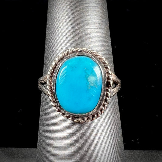 A vintage ladies' Pilot Mountain turquoise ring handmade in sterling silver with a rope accented bezel.