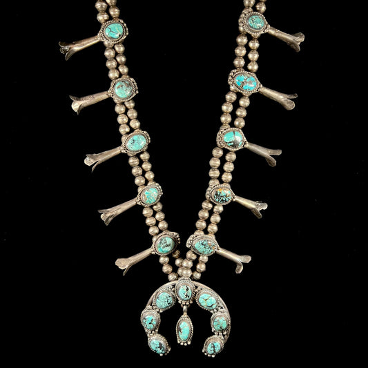 A Native American squash blossom necklace set with Number 8 MIne turquoise stones.