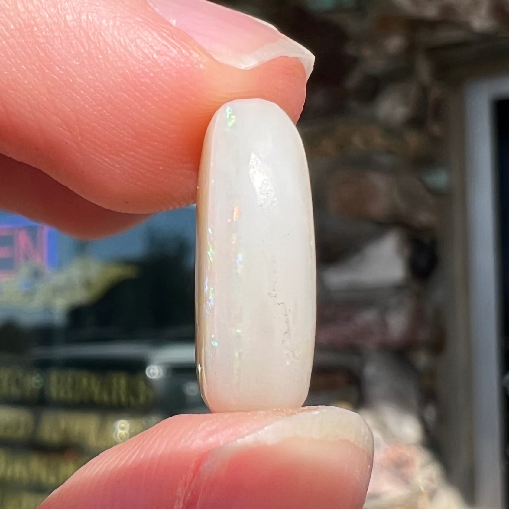 An oval cabochon cut opal from Coober Pedy, Australia.