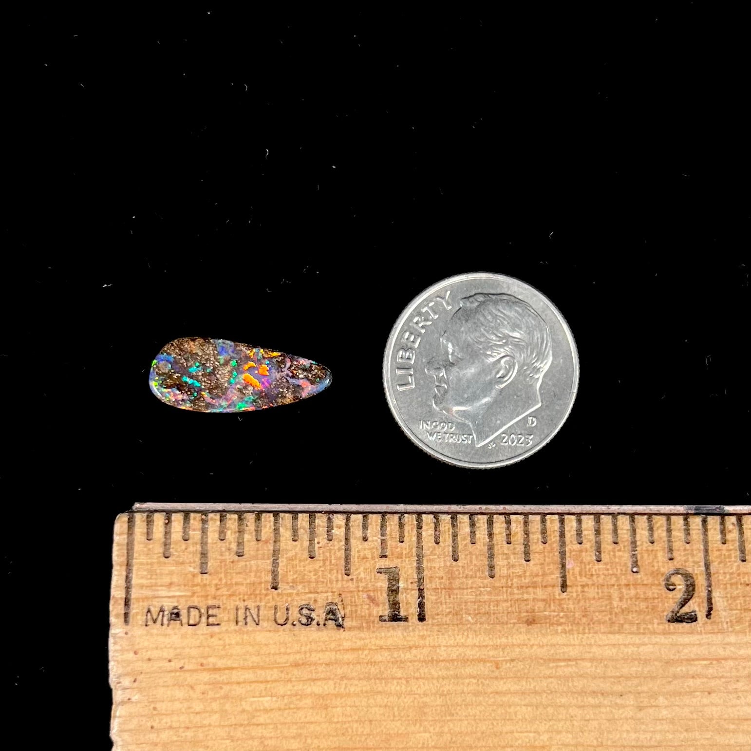 A loose, pear shaped boulder opal stone from Quilpie, Australia.  The opal shines every color of the rainbow.