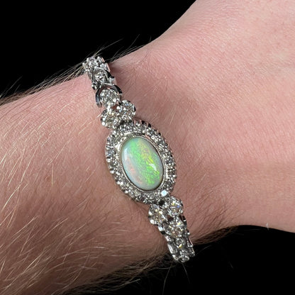 A ladies' vintage, 1930's natural opal bracelet set with accent diamonds in white gold.