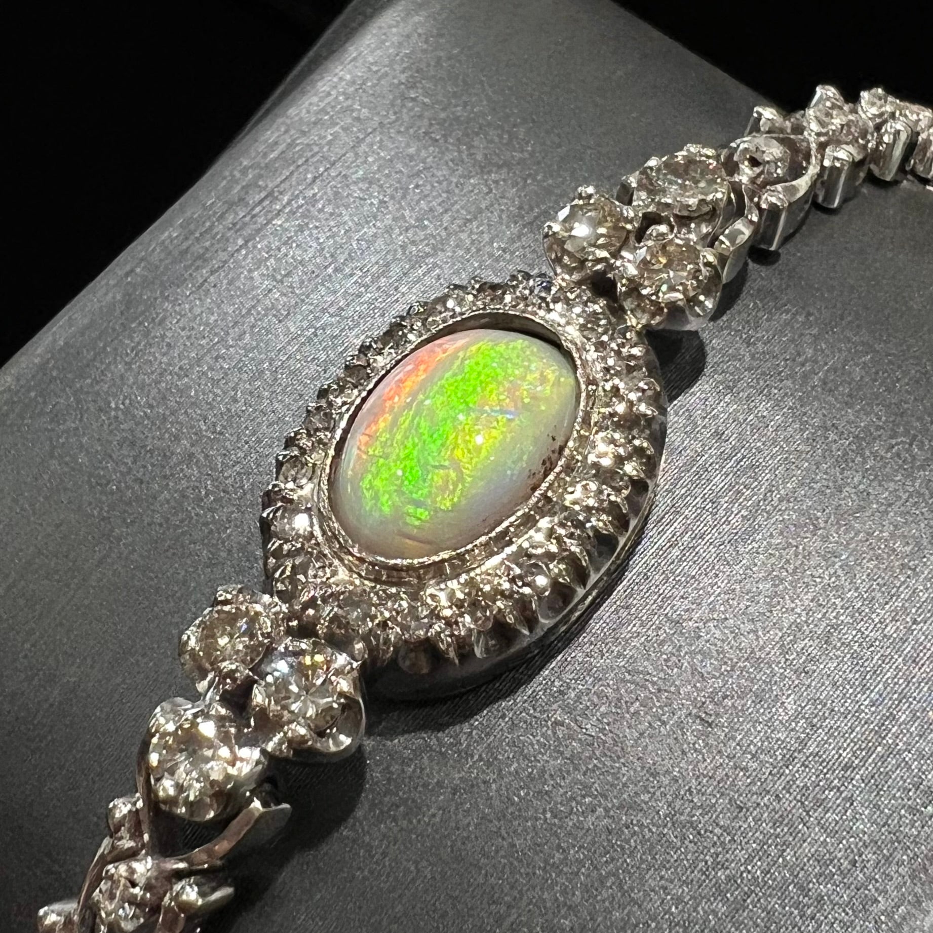 A ladies' vintage, 1930's natural opal bracelet set with accent diamonds in white gold.