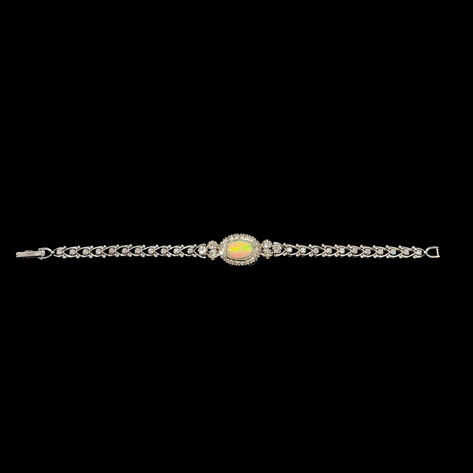 A ladies' vintage, 1930's natural opal bracelet set with accent diamonds in white gold.