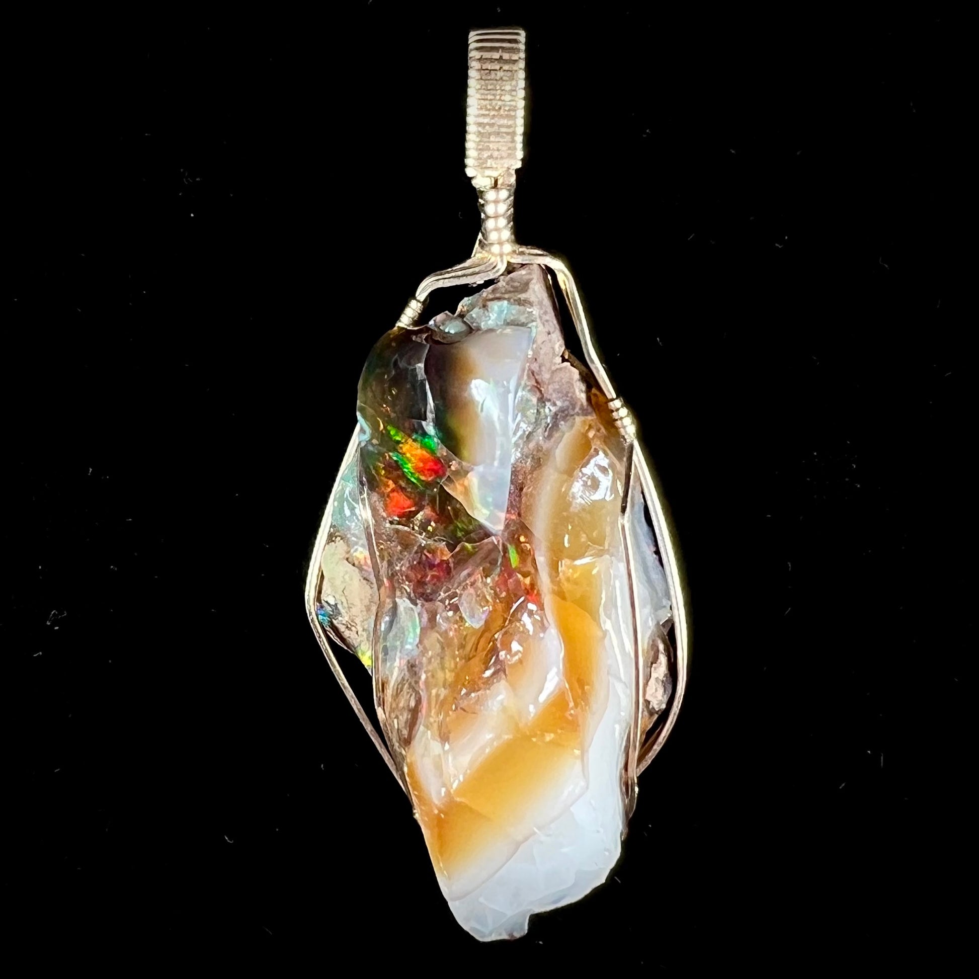 A gold filled wire wrapped pendant set with a natural Virgin Valley, Nevada opal crystal.