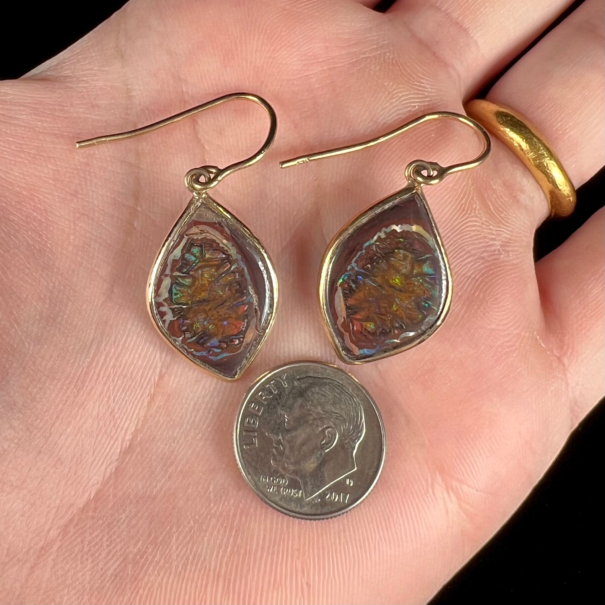 A pair of yellow gold dangle earrings bezel set with natural boulder opals from Koroit, Australia.