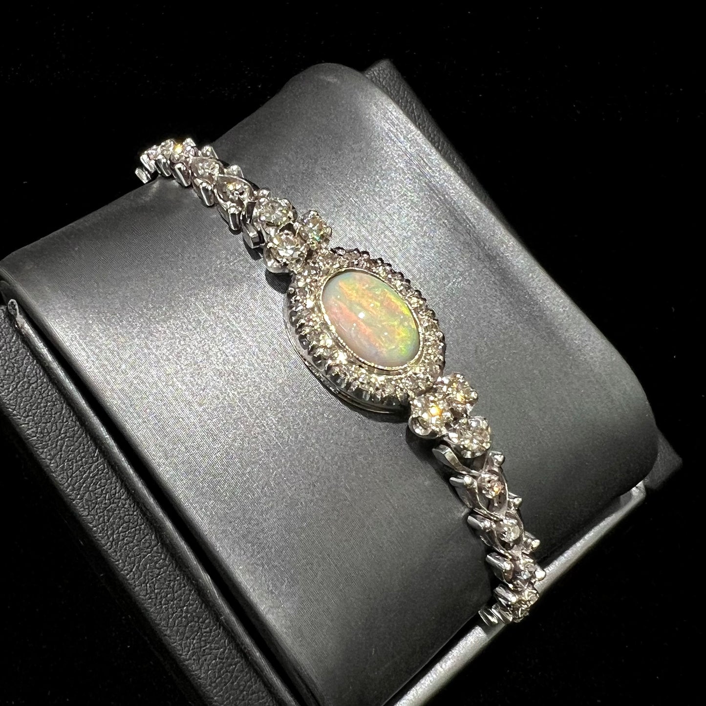 A ladies' vintage, 1930's natural opal bracelet set with accent diamonds in white gold.