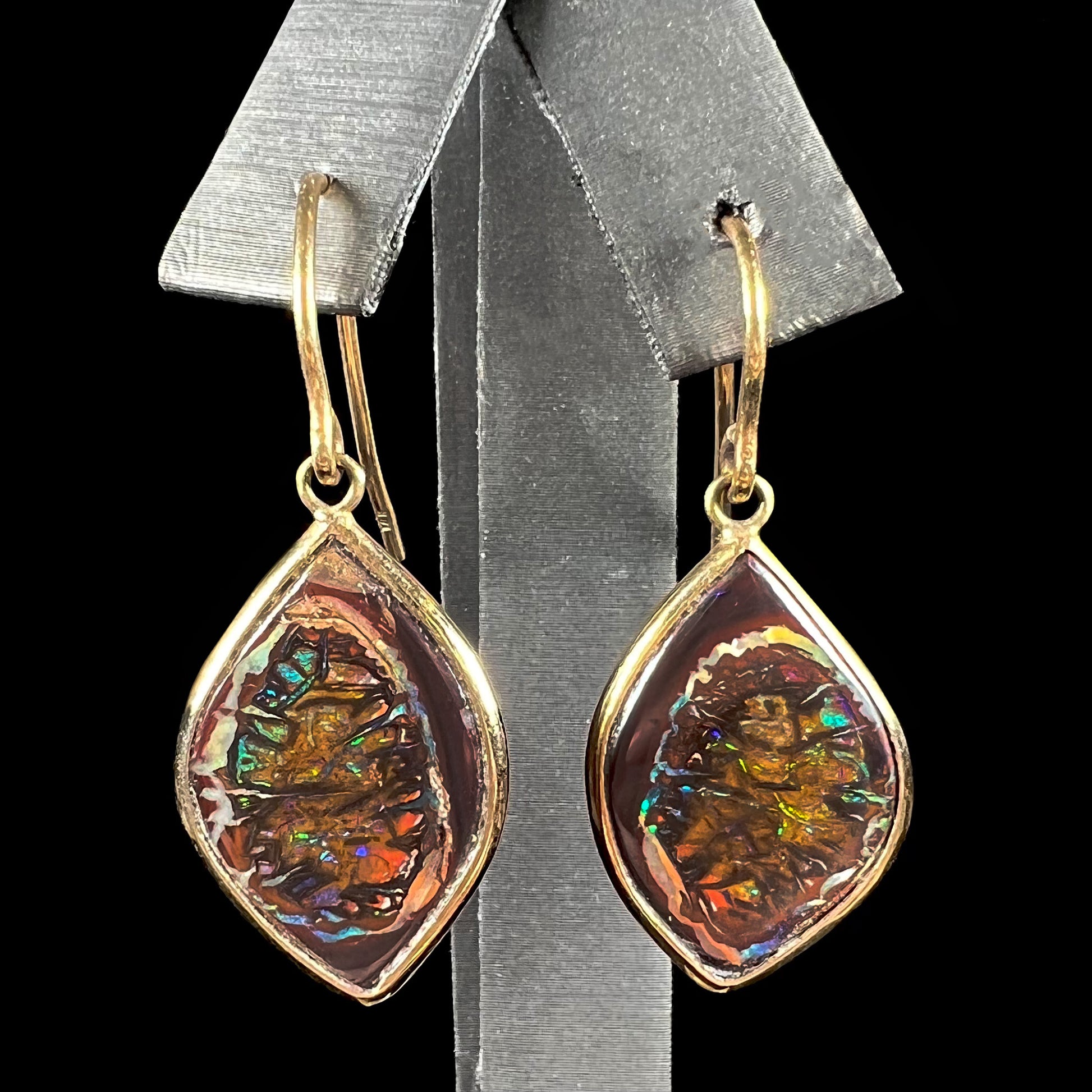 A pair of yellow gold dangle earrings bezel set with natural boulder opals from Koroit, Australia.