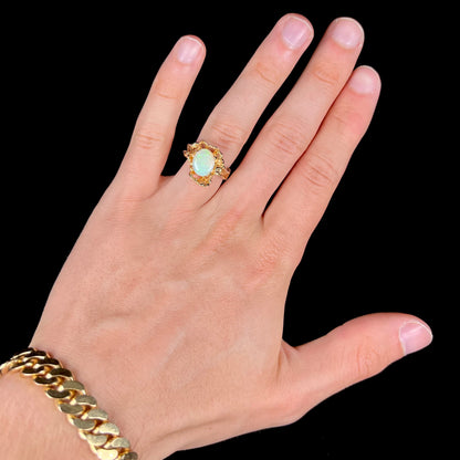 A ladies' organic style yellow gold ring prong set with a natural, green Australian crystal opal.