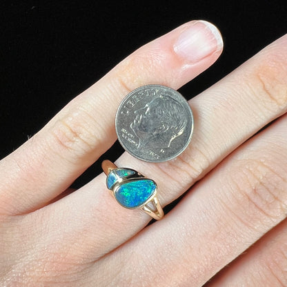 A ladies' black opal inlay ring cast in yellow gold.