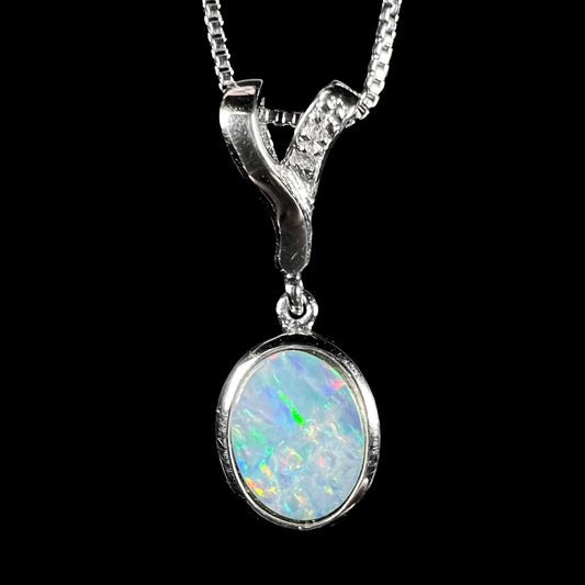 A sterling silver necklace set with a natural black opal doublet and white zircon accent stones.