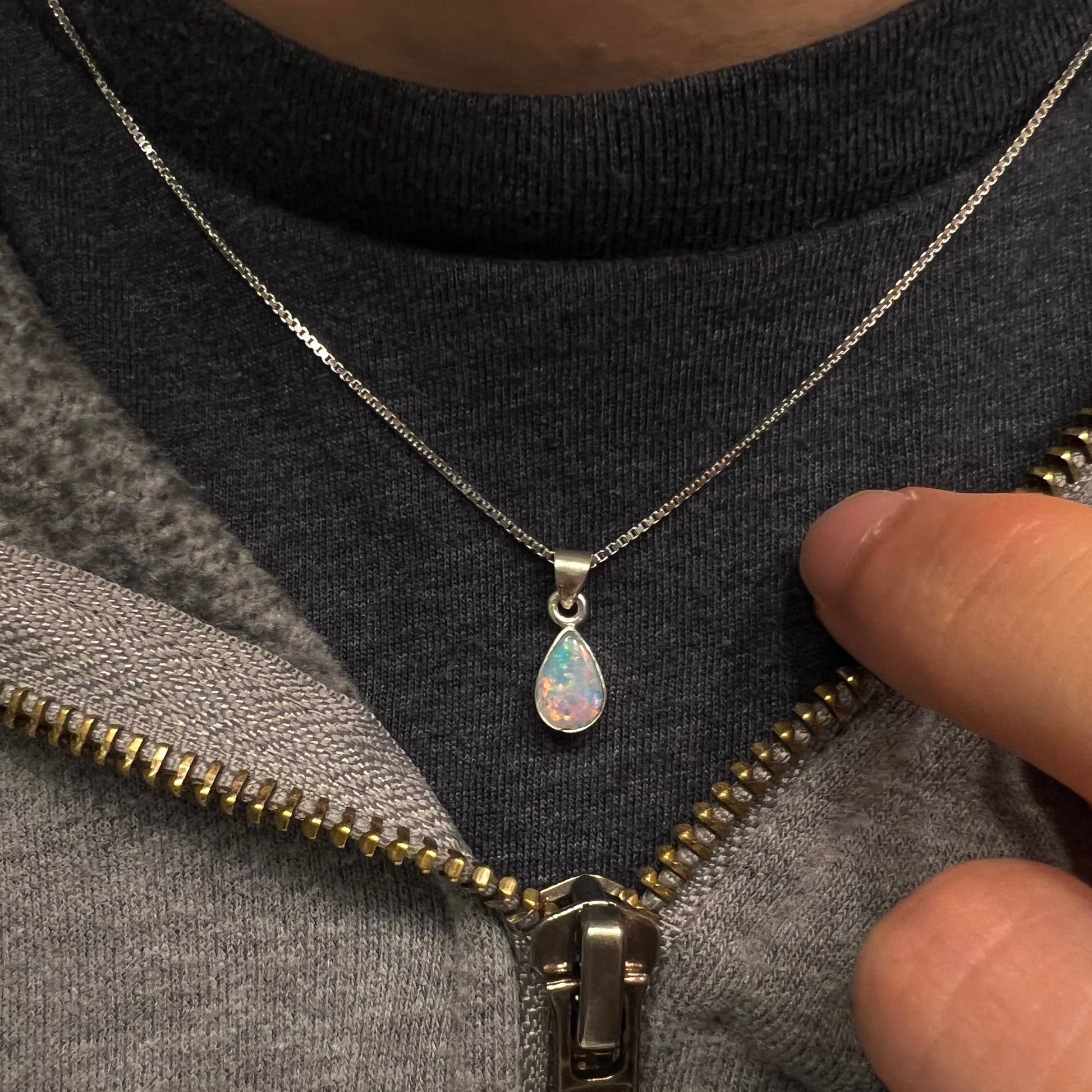 A pear shaped natural crystal opal necklace handmade in sterling silver.