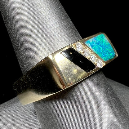 A men's yellow gold ring inlay set with onyx, natural black opal, and four diamonds.