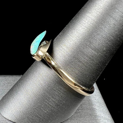 A ladies yellow gold solitaire ring bezel set with a natural opalized seashell from Coober Pedy, Australia.