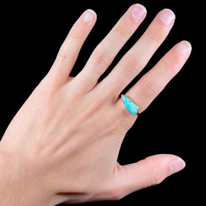 A ladies yellow gold solitaire ring bezel set with a natural opalized seashell from Coober Pedy, Australia.