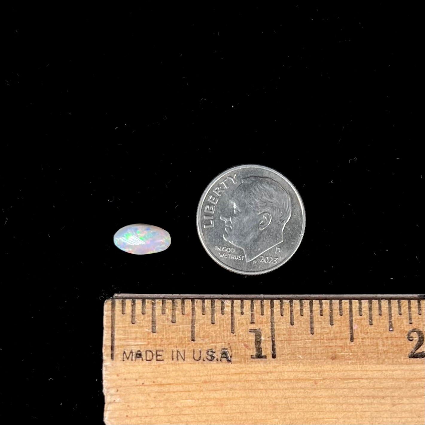 A loose, light opal from Lightning Ridge, Australia.  The opal shines a rainbow of colors.