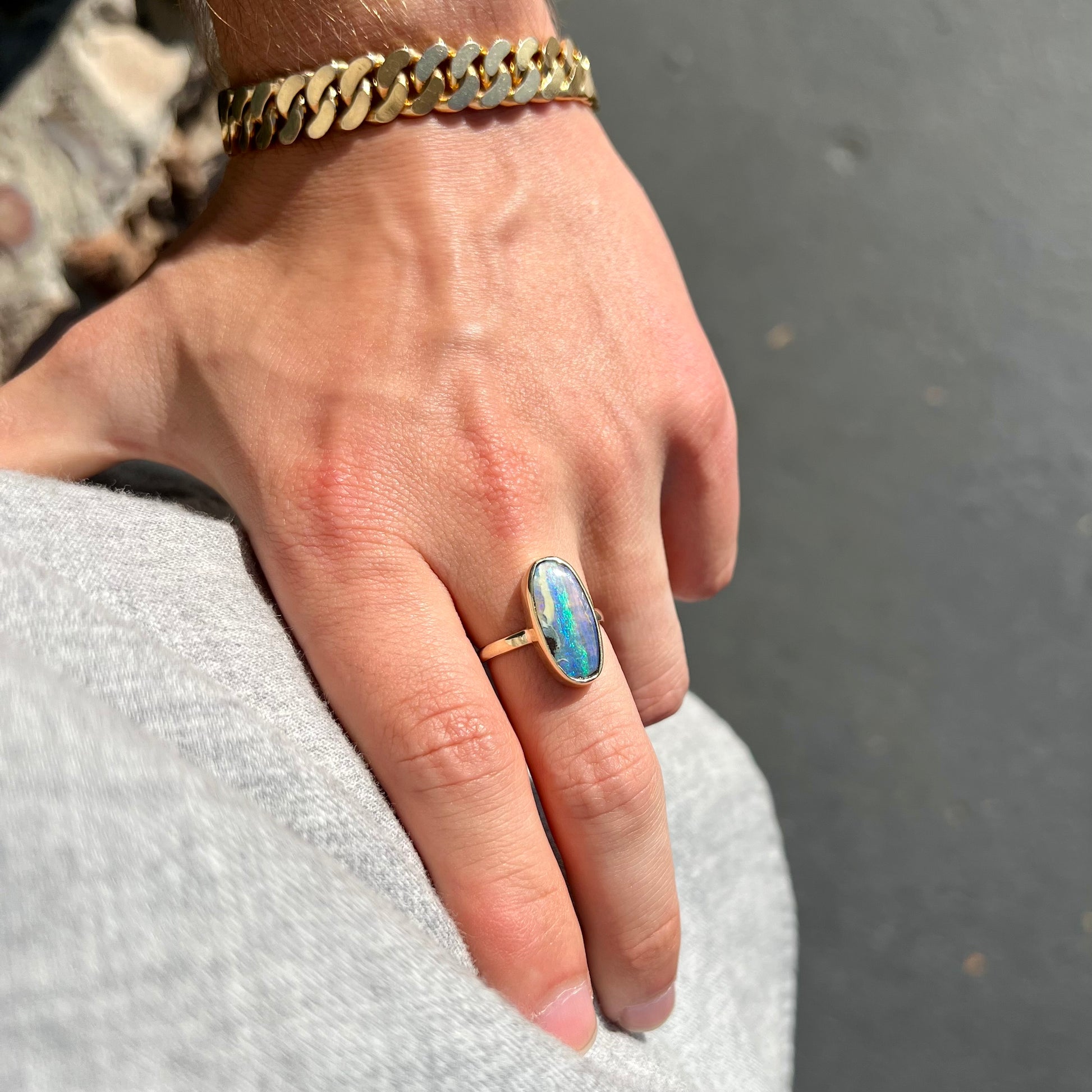 Ladies' yellow gold solitaire ring bezel set with a natural green striped boulder opal from Quilpie, Australia.