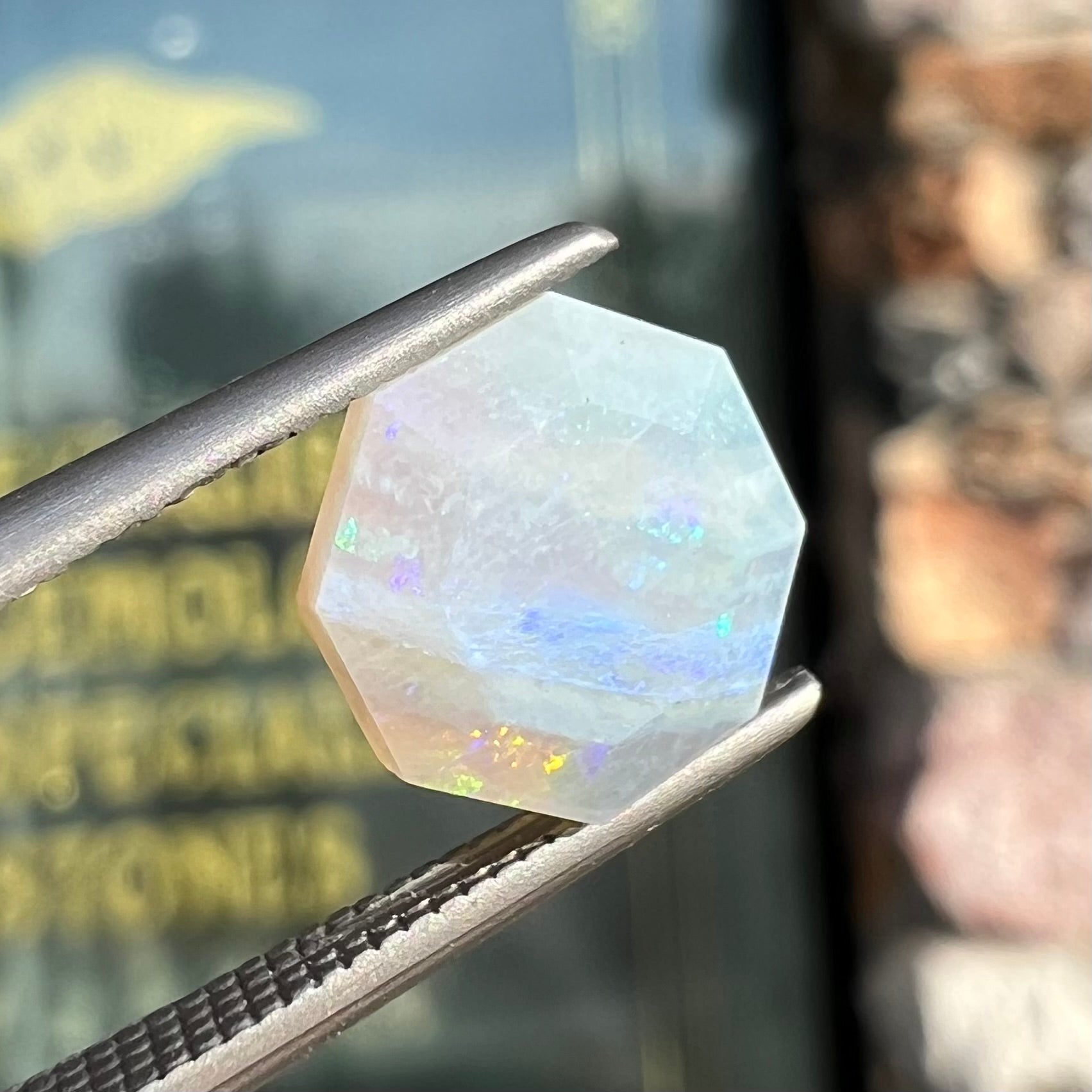 A loose, faceted octagon gray base crystal opal from Lightning Ridge, Australia.