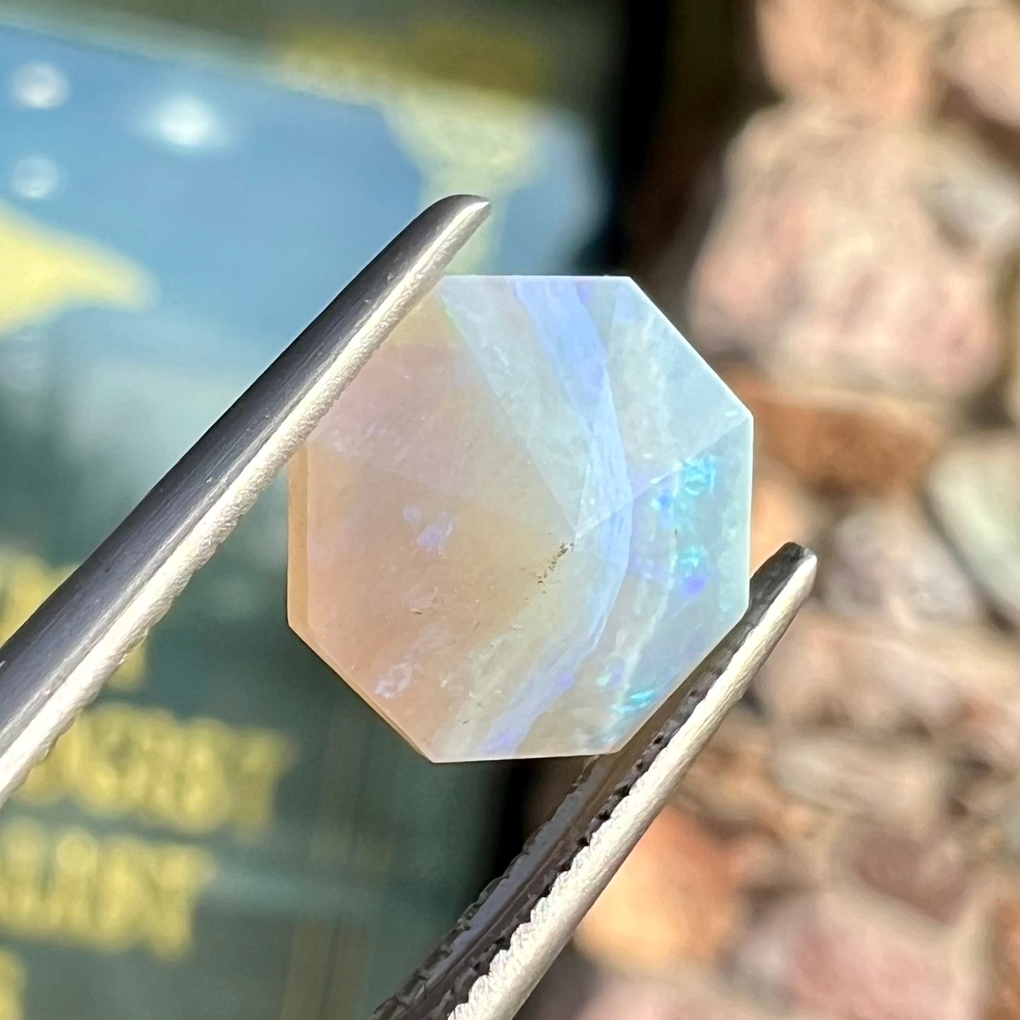 A loose, faceted octagon gray base crystal opal from Lightning Ridge, Australia.
