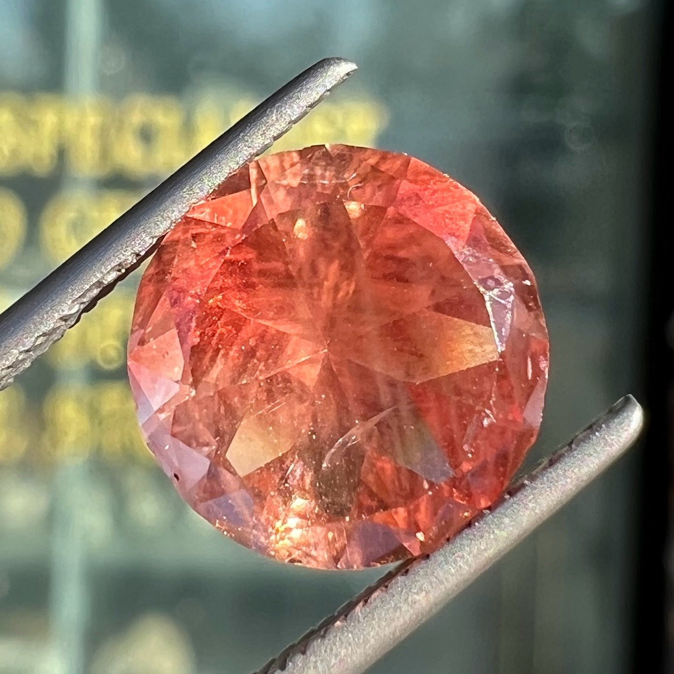 A loose, round brilliant cut Oregon sunstone gem.