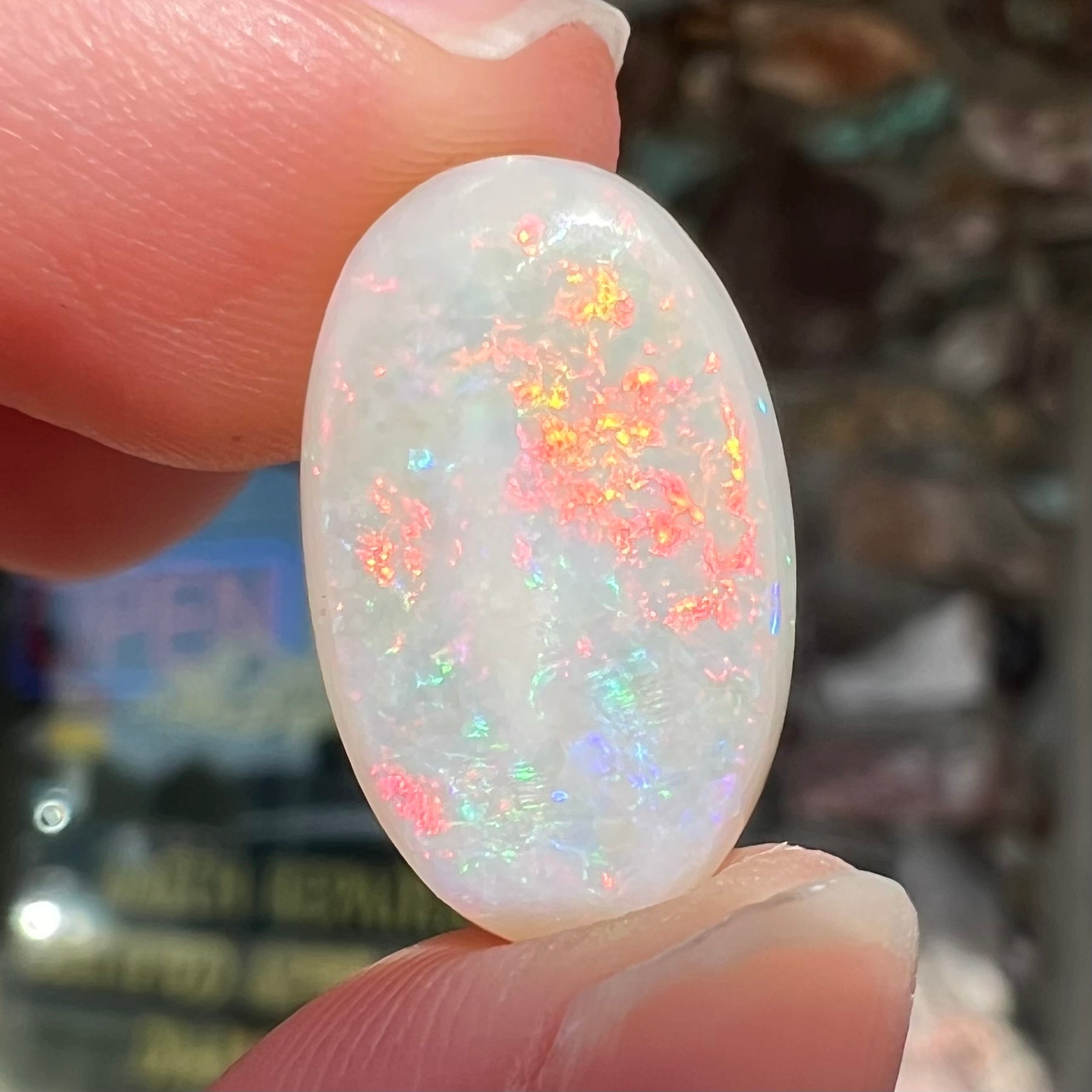 An oval cabochon cut opal from Coober Pedy, Australia.  The opal has predominantly red fire.