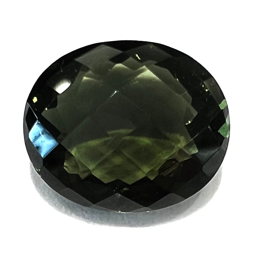 A loose, oval cut natural moldavite gemstone.  The stone weighs 3.85 carats.