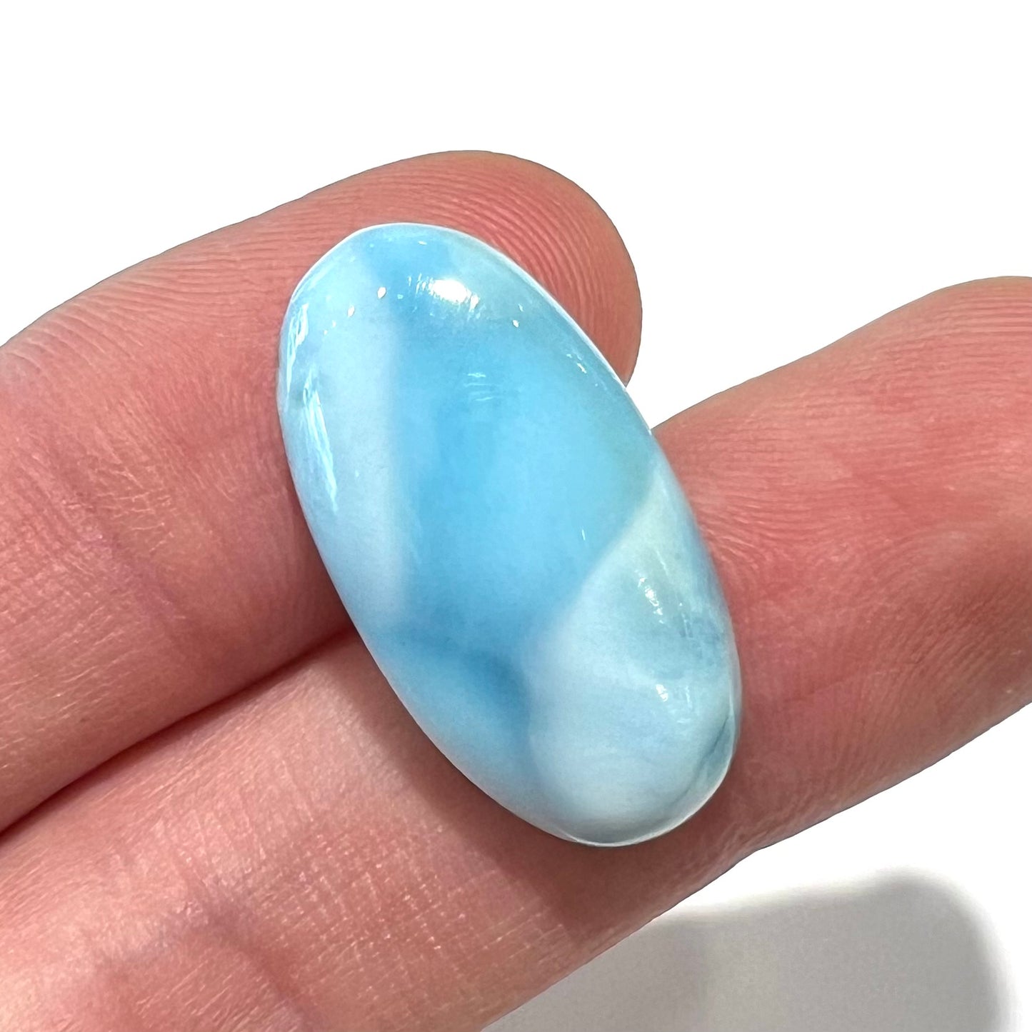 A loose, oval cabochon cut larimar stone from Dominican Republic.