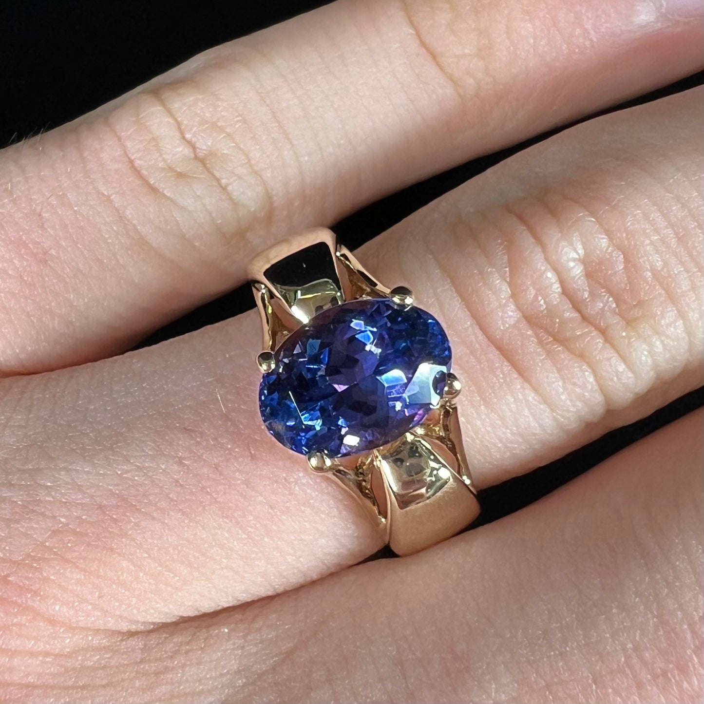 A ladies' oval cut tanzanite solitaire ring set in yellow gold.