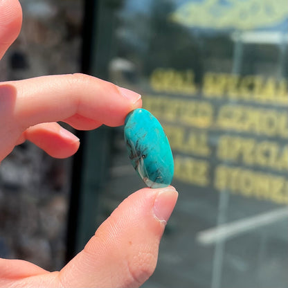 A loose, oval cabochon cut turquoise stone from Royston District, Nevada.