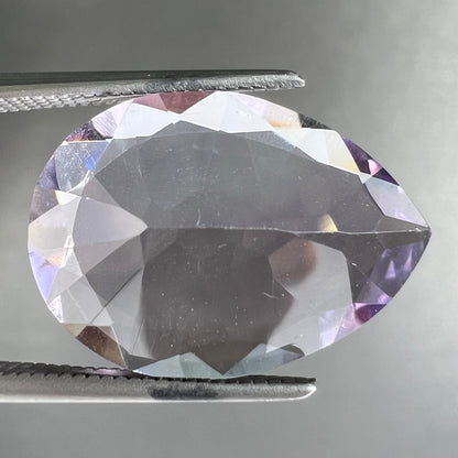 A faceted pear shaped rose de France colored amethyst gemstone.