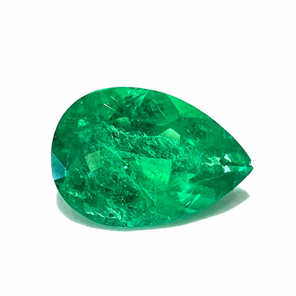 A loose, pear shaped natural emerald gemstone.