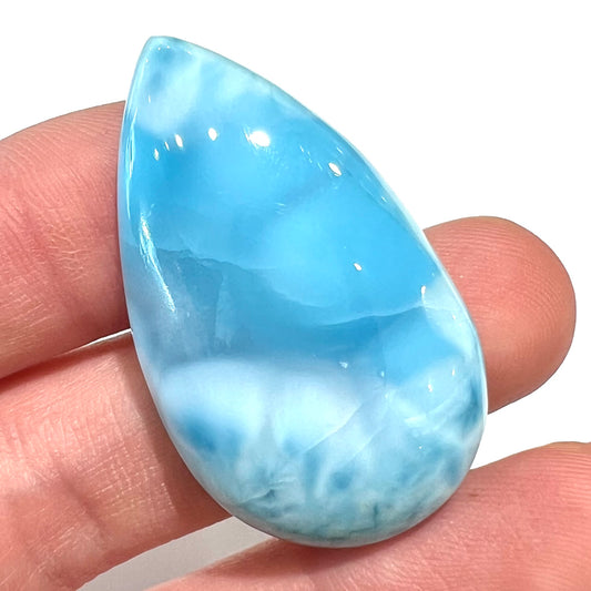 A loose, pear shaped larimar cabochon.  The material is AAA+ grade.