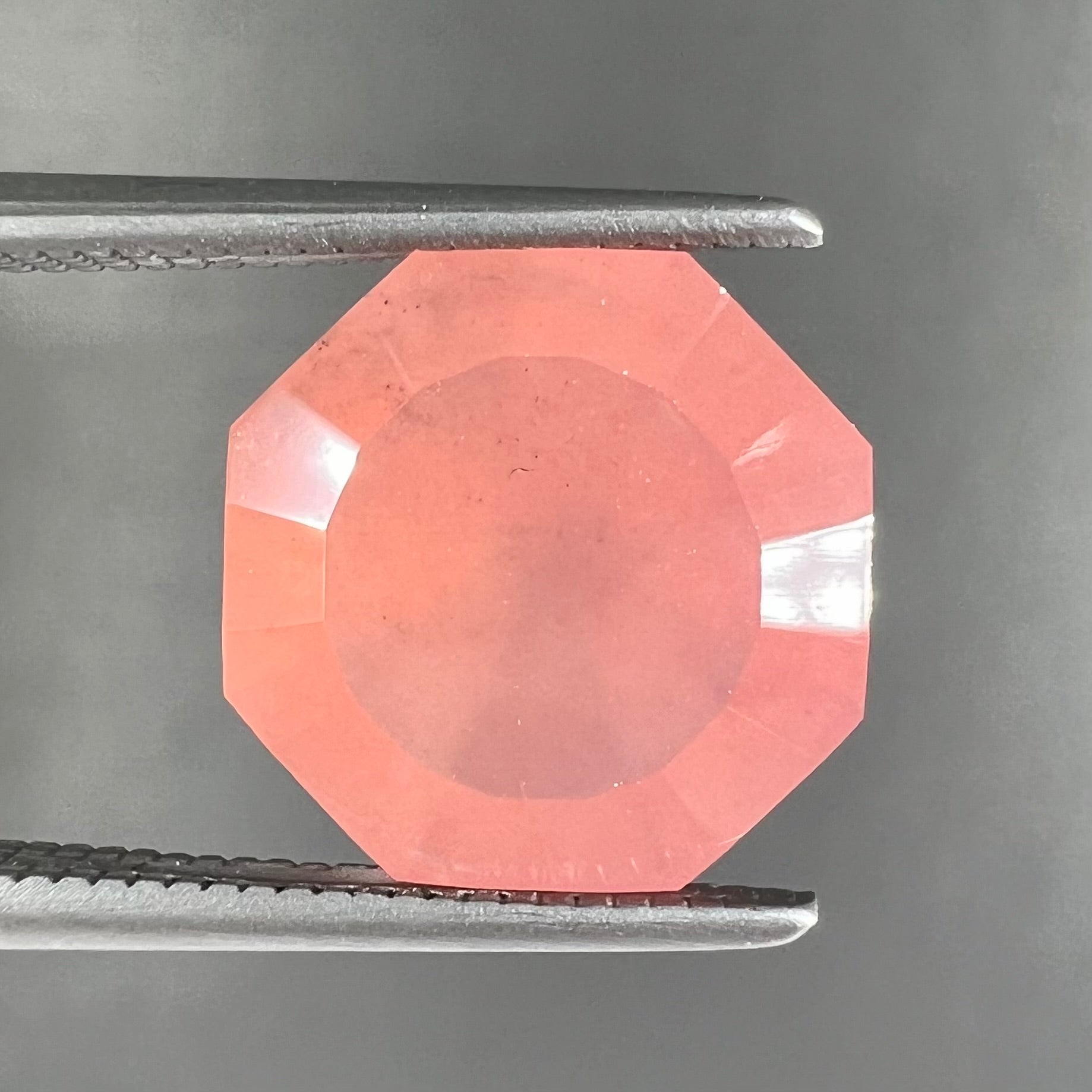 A faceted, octagon cut pink fire opal from Mexico.