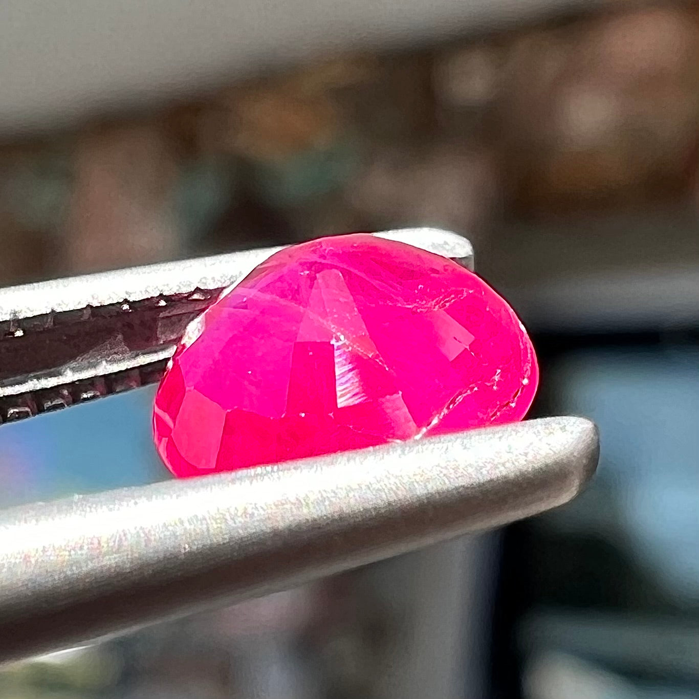 A faceted round brilliant cut Burma ruby gemstone.  The stone is certified as natural by Guild Laboratories.