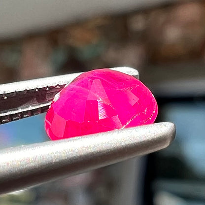 A faceted round brilliant cut Burma ruby gemstone.  The stone is certified as natural by Guild Laboratories.